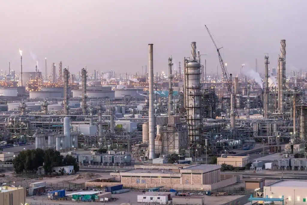 Industrial oil refinery with pipelines and chimneys in Dubai.