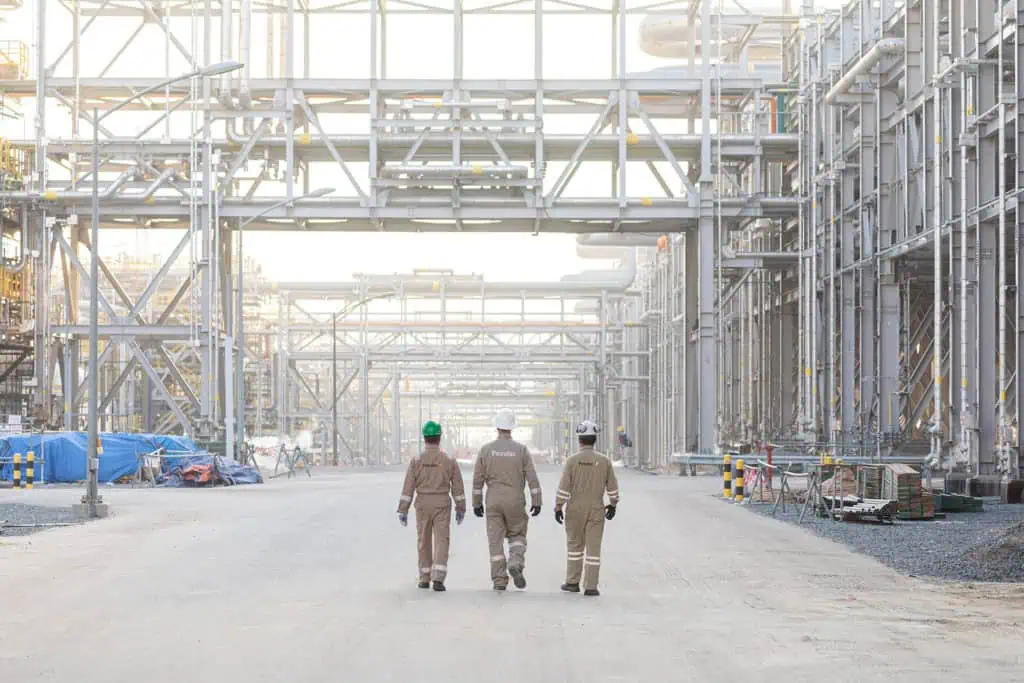 Workers inspecting oil and gas industrial plant in Dubai.