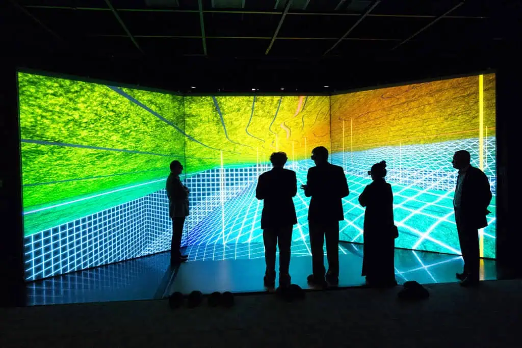 Business professionals viewing a digital data visualization in Dubai.
