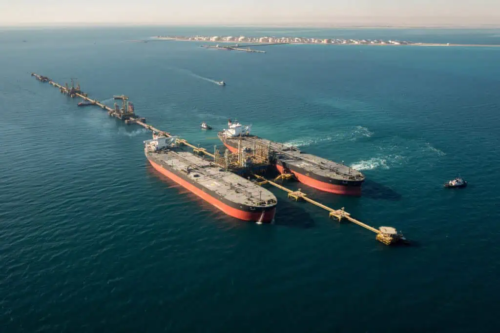Offshore oil and gas platform in KSA with ships and pipelines.