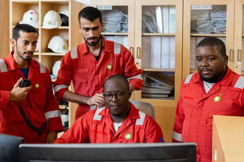 Oil and gas professionals collaborating in Dubai office.