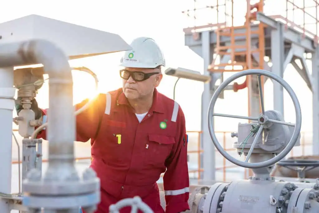 Oil and gas engineer inspecting equipment at an industrial site.