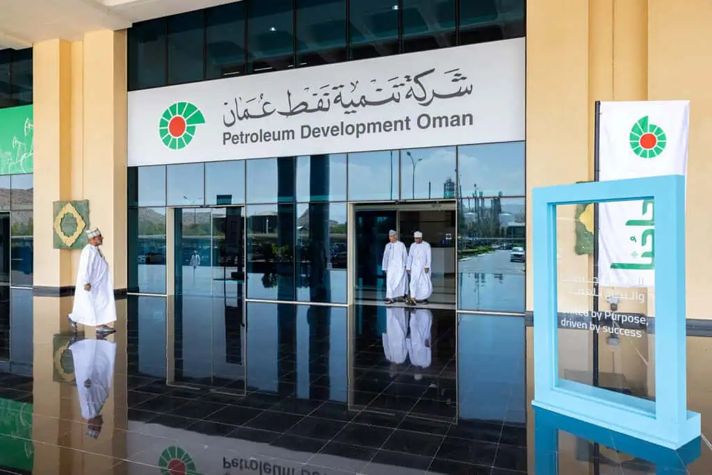 Modern Petroleum Development Oman office in Dubai with staff outside.