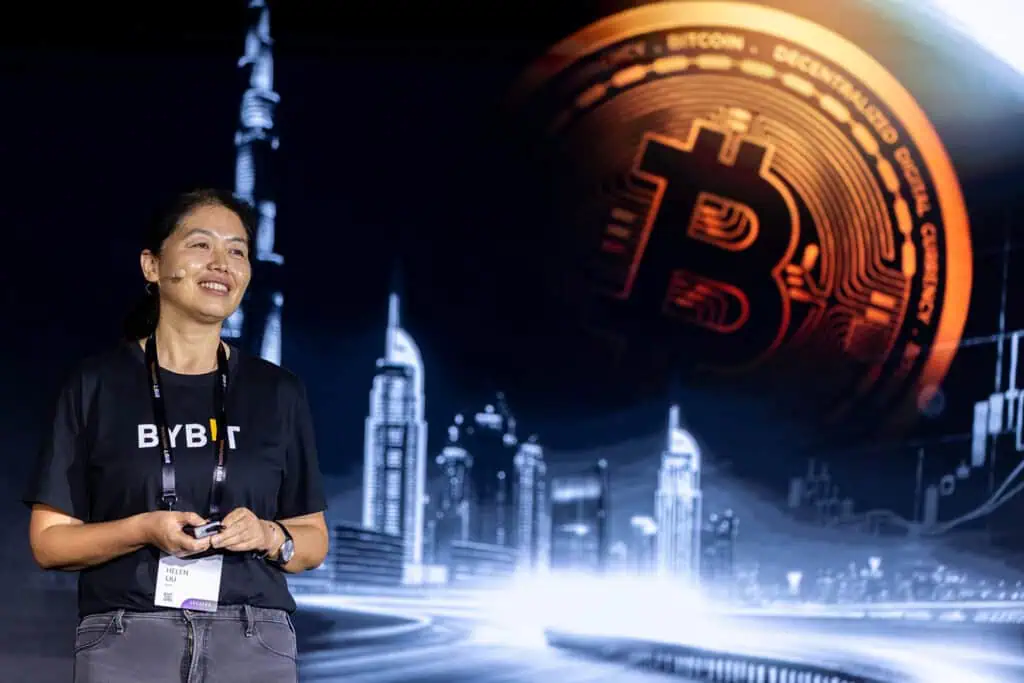 Professional woman at a conference with Bitcoin digital background in Dubai.