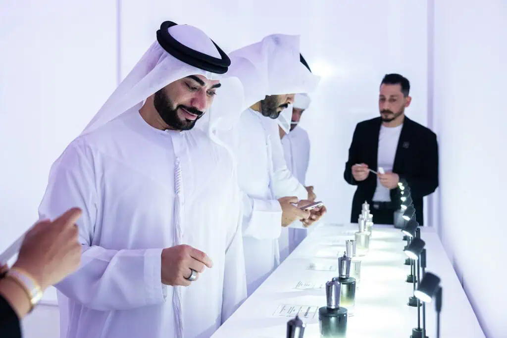 Business professionals exploring product display at Dubai corporate event.