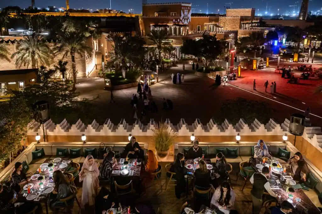 Nighttime corporate dining scene with cityscape view in Dubai.