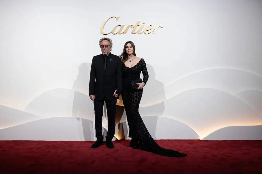 Monica Belluci and Tim Burton at Cartier event in Dubai with Cartier logo.