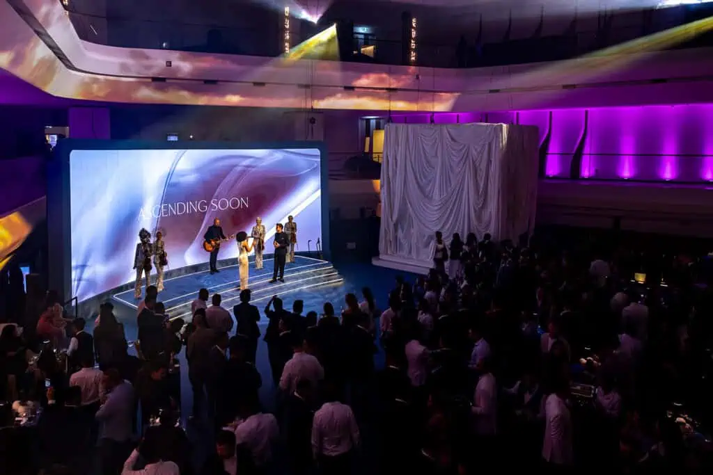 Live corporate event in Dubai with stage performance and audience.